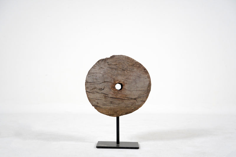 A Wooden Wheel Pulley on a Metal Stand