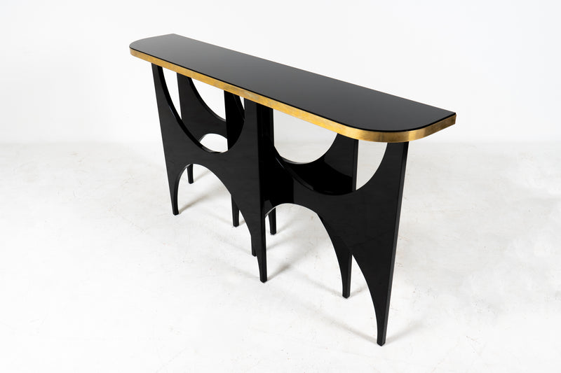 A Modern Console Table With Lacquered Base and Black Glass Top
