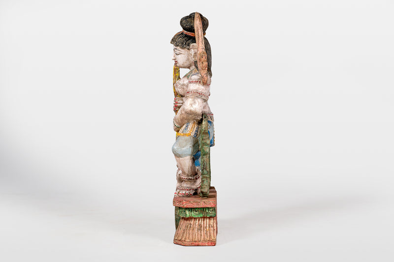 A Wooden Sculpture of a Musician Angel Playing Flute