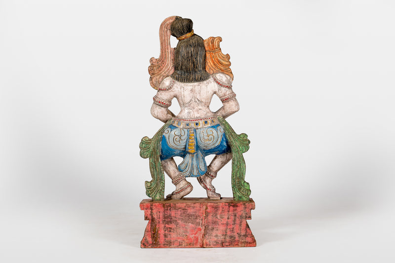 A Wooden Sculpture of a Musician Angel Playing Flute