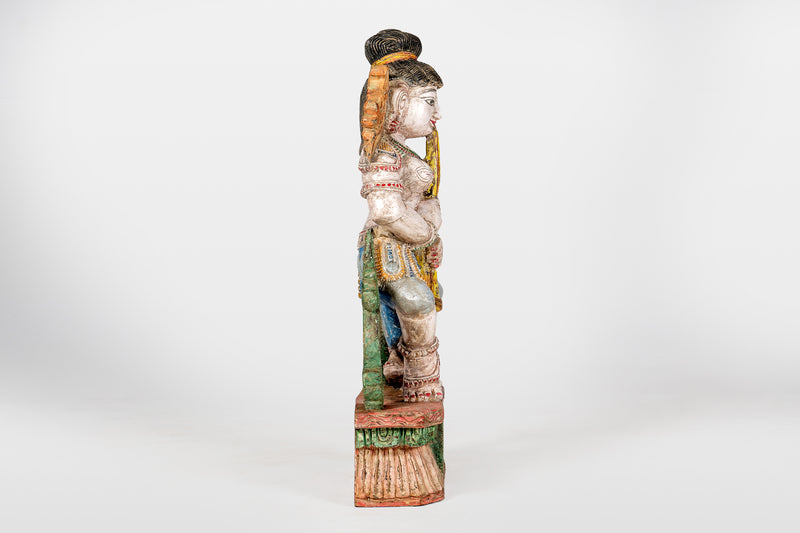 A Wooden Sculpture of a Musician Angel Playing Flute