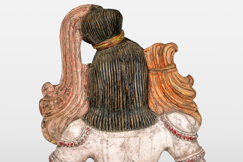 A Wooden Sculpture of a Musician Angel Playing Flute