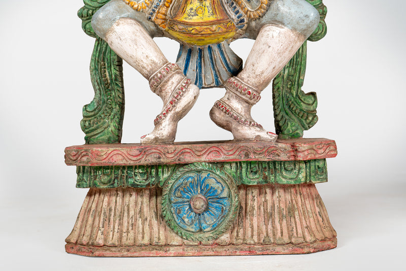 A Wooden Sculpture of a Musician Angel Playing Flute