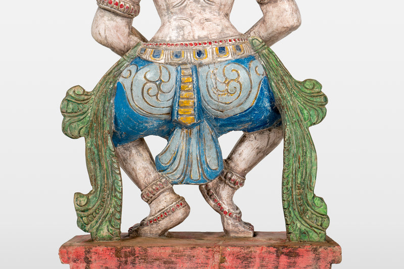 A Wooden Sculpture of a Musician Angel Playing Flute