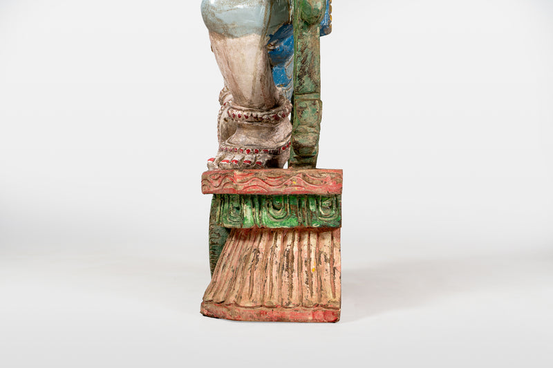 A Wooden Sculpture of a Musician Angel Playing Flute