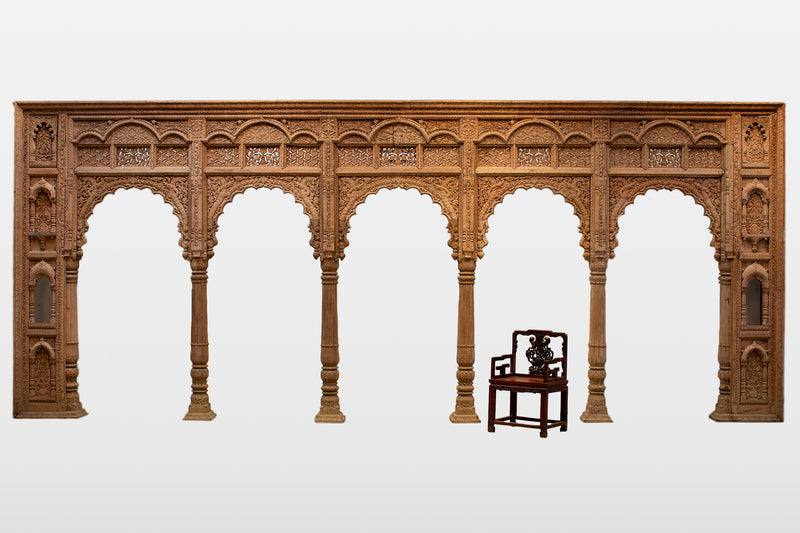 A Wooden Indian Colonnade With Five Arches and Candle Alcoves
