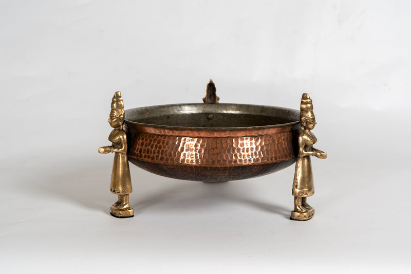 A Stippled Copper Cooking Vessel with Brass Figures