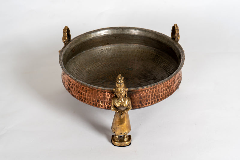 A Stippled Copper Cooking Vessel with Brass Figures
