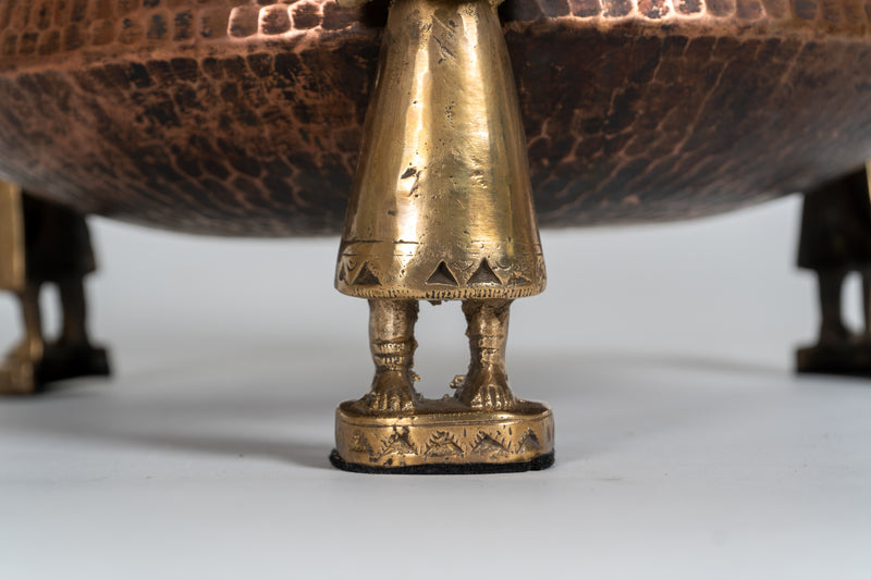 A Stippled Copper Cooking Vessel with Brass Figures