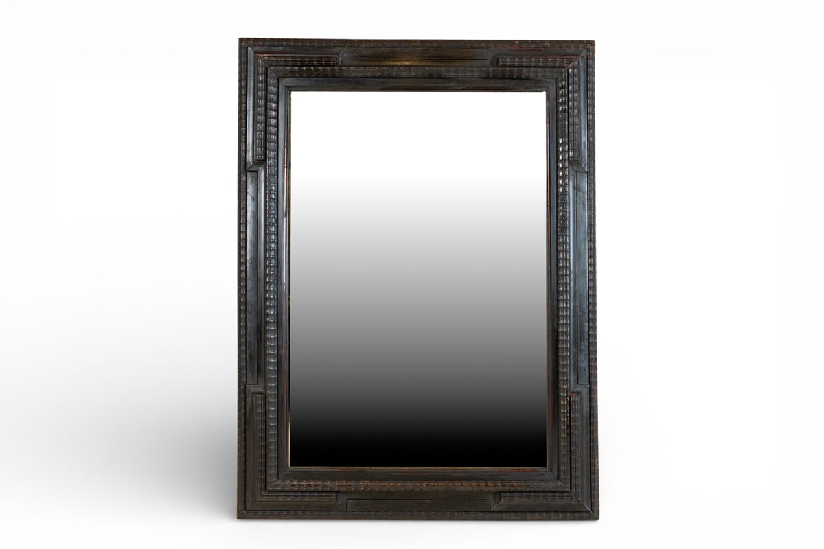 A Northern Italian Ebonized Mirror Frame in the Flemish Style