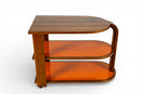 A Vintage Art Deco Style Bar Cart With Orange Glass Shelves
