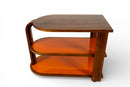 A Vintage Art Deco Style Bar Cart With Orange Glass Shelves