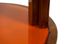 A Vintage Art Deco Style Bar Cart With Orange Glass Shelves