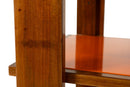 A Vintage Art Deco Style Bar Cart With Orange Glass Shelves