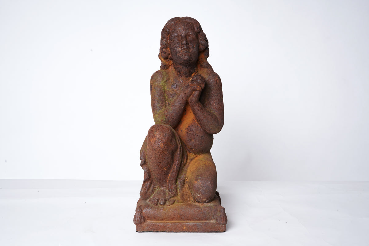 A Cast Iron Figure of a Young Boy