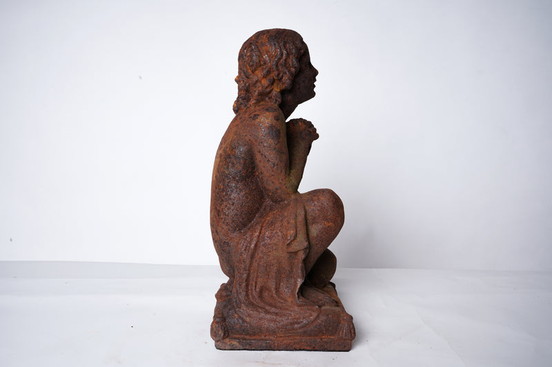 A Cast Iron Figure of a Young Boy