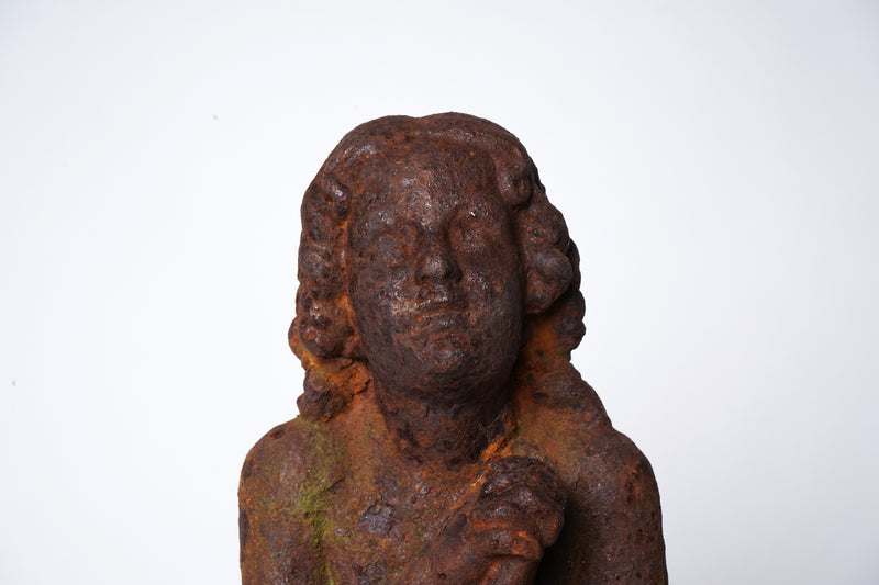 A Cast Iron Figure of a Young Boy