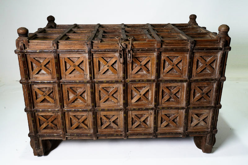A Large Indian Storage Chest On Wheels