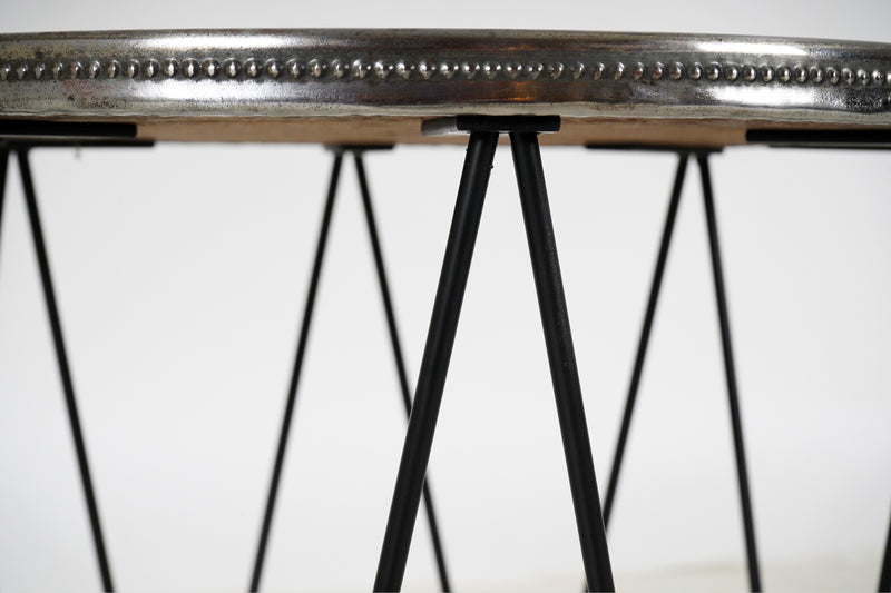 A Round Side Table with 8 Iron Legs And Embossed Metal Top