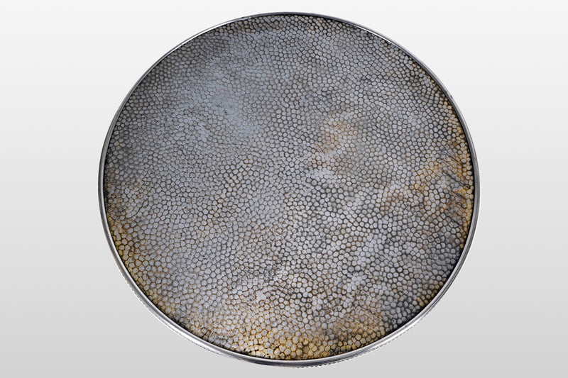 A Round Side Table with 8 Iron Legs And Embossed Metal Top