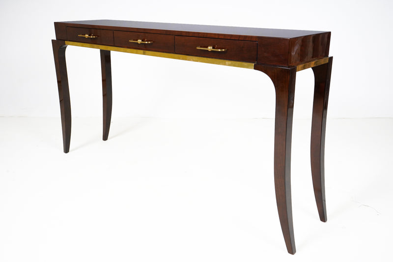 A console with three drawers and curved legs, with Brass triming