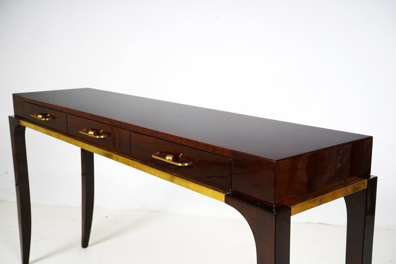 A console with three drawers and curved legs, with Brass triming