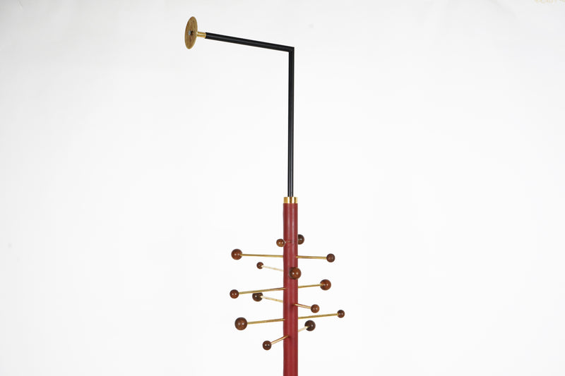 A Wall-Mounted Coat Rack In Walnut and Brass