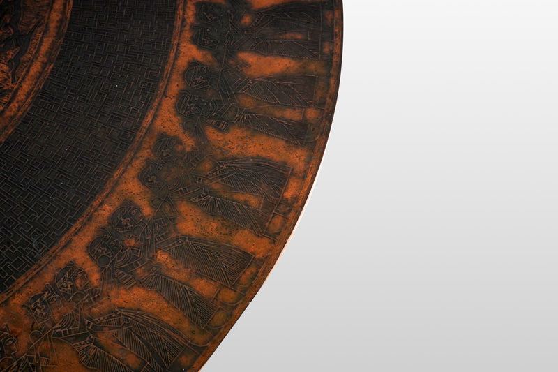 A Round Coffee Table with Embossed Top